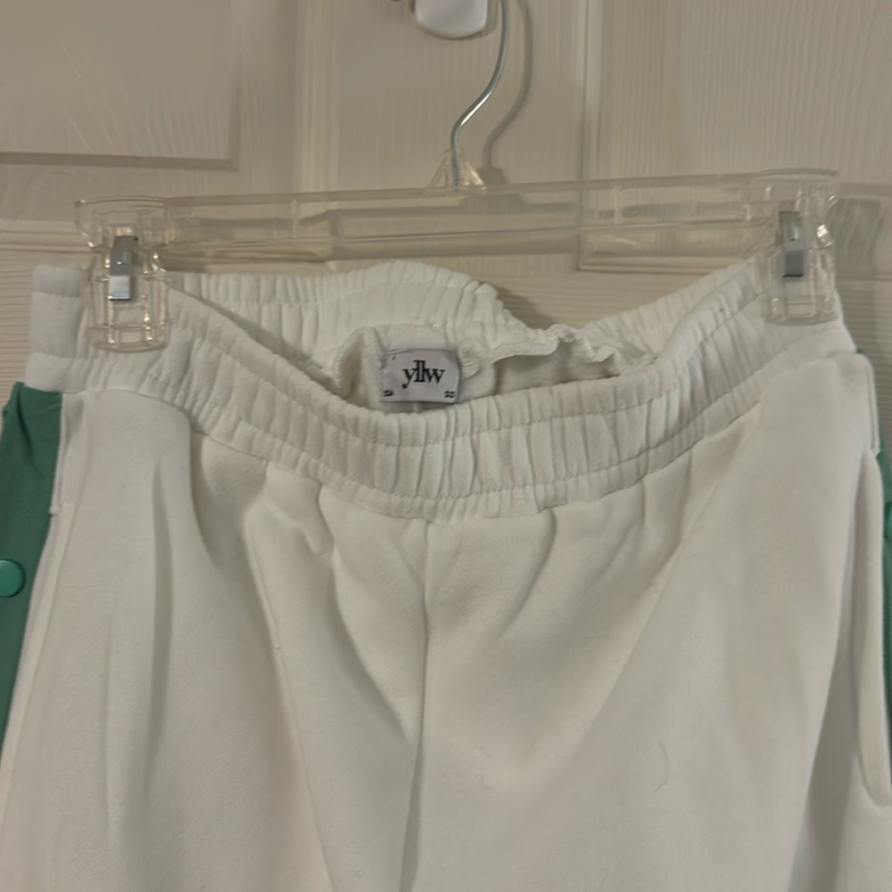 White and green track sweat pants.